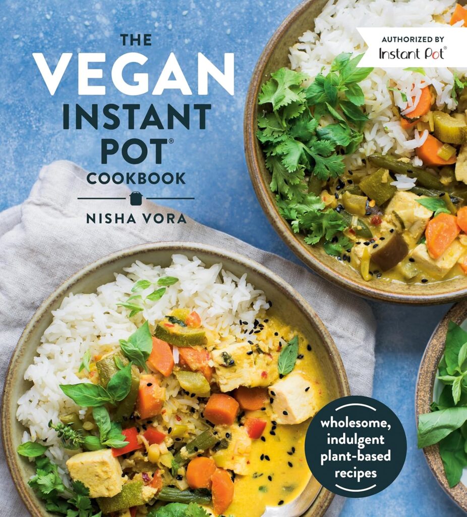 Vegan Instant Pot Cookbook next to an Instant Pot in a kitchen